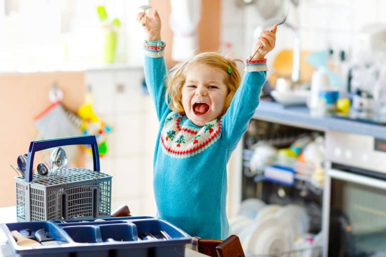 Niña feliz por haber ordenado los cubiertos