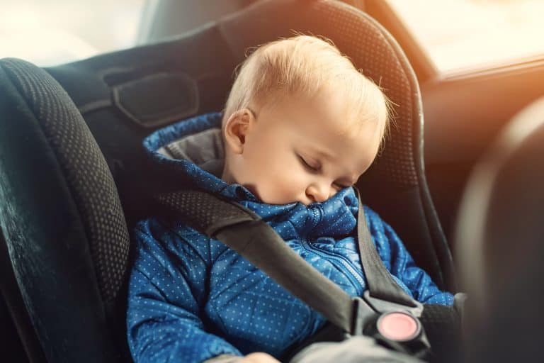 Cute Caucasian Toddler Boy Sleeping In Child Safety Seat In Car During Road Trip. Adorable Baby Drea