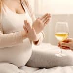 Alcohol Prohibited. Pregnant Woman With Crossed Hands Refusing To Drink Wine, Making Denying Gesture