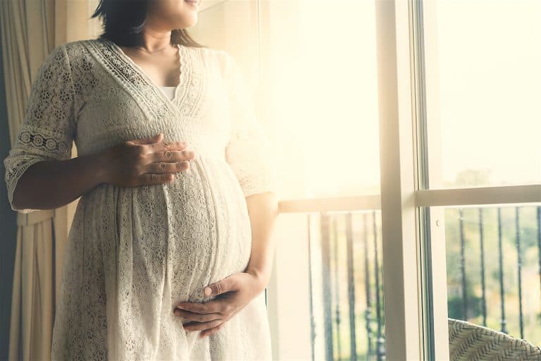 Happy Pregnant Woman And Expecting Baby At Home.